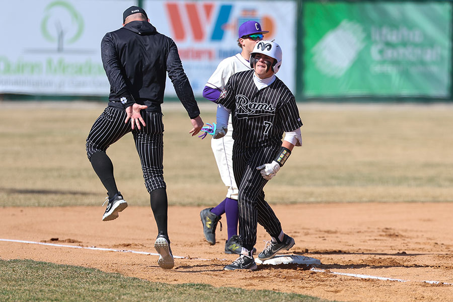 Highland Cooper Colonel celebrates with coach and father Christian Colonel following a two-run triple