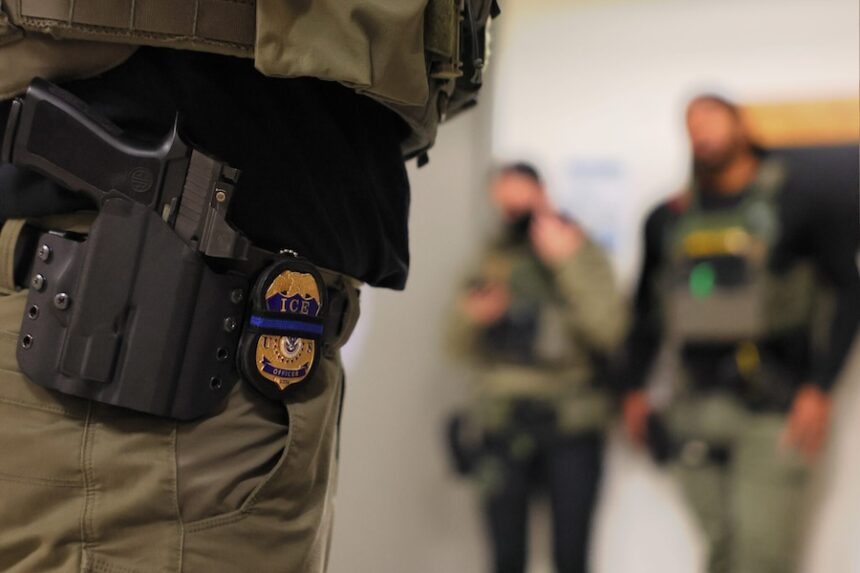 An Immigration and Customs Enforcement officer’s badge is seen as federal agents patrol the halls of immigration court in New York City on June 10, 2025.