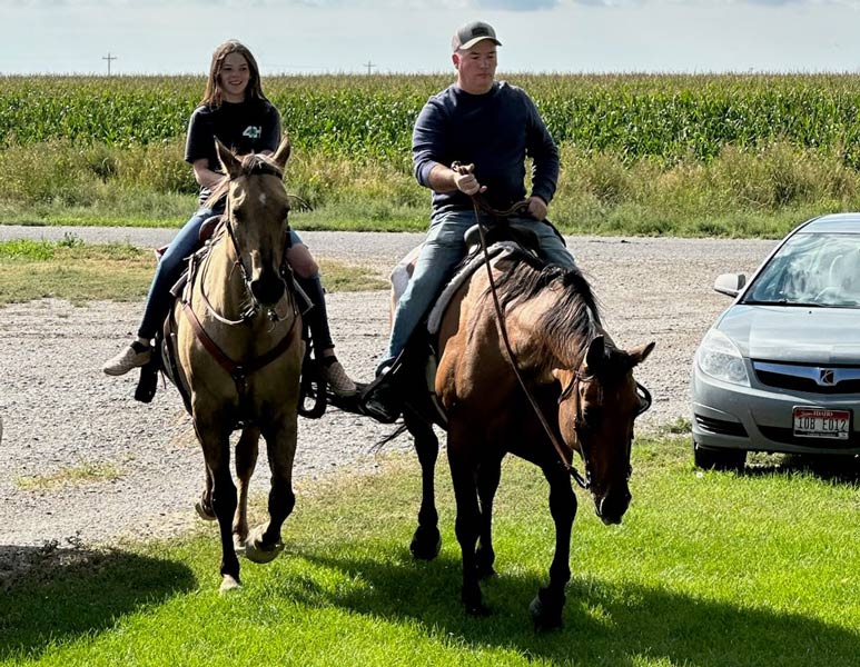 Dean Haight rides horses with one of his children in this undated image. | Courtesy of Mike Anderson