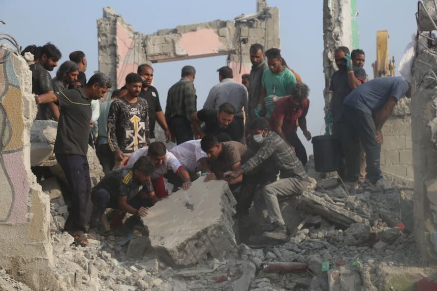 rescuers at rubble of Iran school