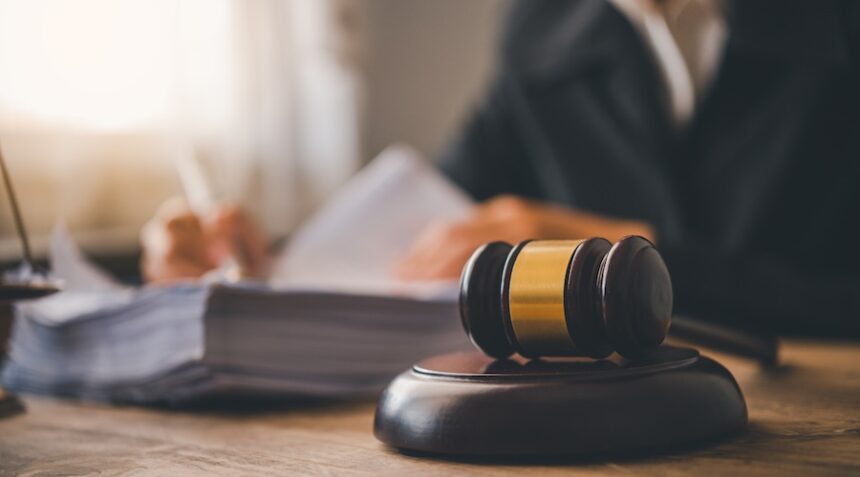 Law theme, mallet of the judge, law enforcement officers, evidence-based cases, and documents taken into account.