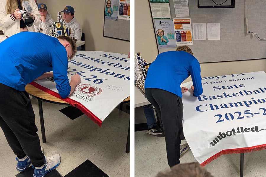 Rockland seniors Woodrow Lowder (left) and Isaac Held sign the championship banner