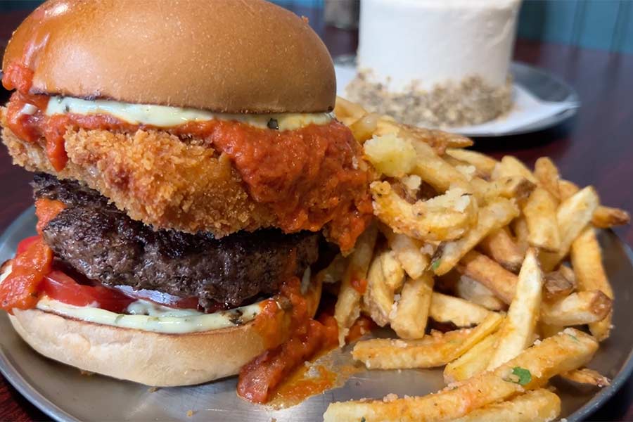 Mozzarella Explosion burger served with a chunk of fried mozzarella cheese, tomoato bisque, tomato and pesto mayo on a brioche bun. A side of Tuscan herb & oil fries makes it hit the spot. | Rett Nelson, EastIdahoNews.com