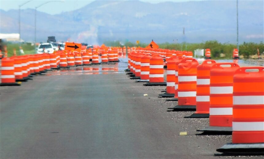 ORANGE! Rows of bright and colorful orange construction cones, redirecting traffic during construction on the highway.
