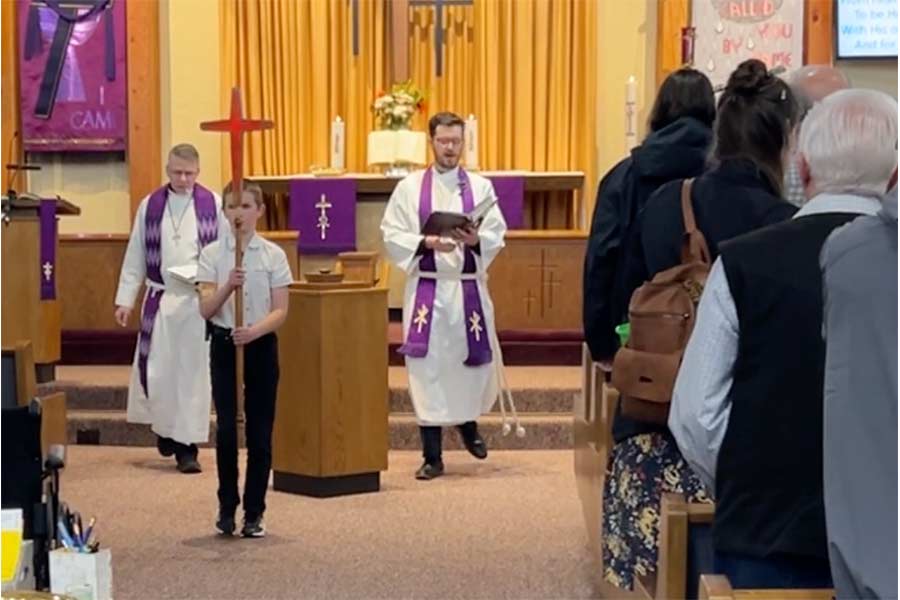 Pastors Garen Pay, right, and Robert Carabotta, left, being led by a boy holding a cross to the groundbreaking ceremony. | Rett Nelson, EastIdahoNews.com
