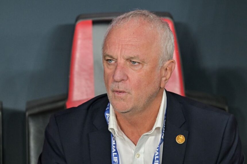 FILE- Iraqi's head coach Graham Arnold sits on the bench at the start of the 2026 World Cup play off first leg soccer match between UAE and Iraq in Abu Dhabi, United Arab Emirates, Friday, Nov. 14, 2025. (AP Photo/Walid Ibrahim, File)