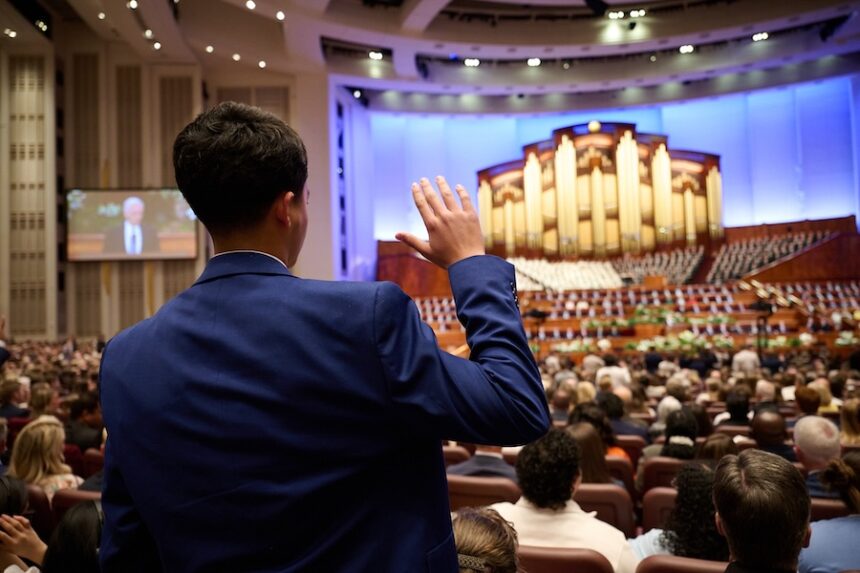 A young man takes part in the sustaining of President Dallin H. Oaks as prophet, seer, revelator and president of The Church of Jesus Christ of Latter-day Saints during a solemn assembly of Church members worldwide at general conference at the Conference Center in Salt Lake City, Utah, on Saturday, April 4, 2026. |