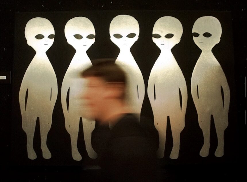 A patron passes a painting inside the International UFO Museum and Research Center in Roswell, N.M., on June 10, 1997.