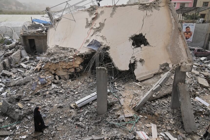 A woman checks a destroyed house that was hit in an Israeli airstrike in Saksakiyeh village, south Lebanon, Friday, April 3, 2026.