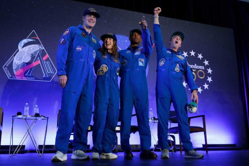 The Artemis II crew, from left, Jeremy Hansen, Christina Koch, Victor Glover and Reid Wiseman come to the center stage at the end of a crew return event Saturday, April 11, 2026, at Ellington Field in Houston.