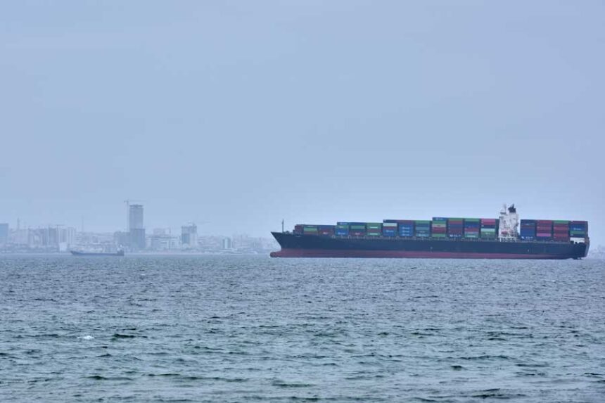 A container ship is seen in the Strait of Hormuz off the coast of Qeshm Island, Iran, Saturday, April 18, 2026.