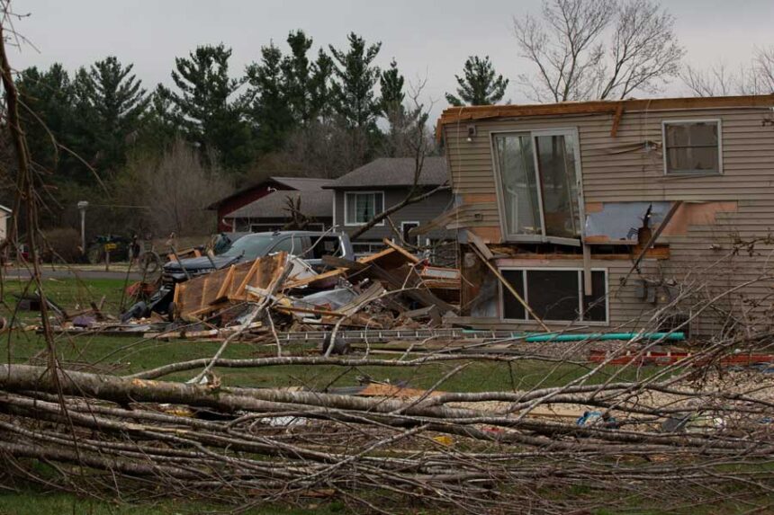 Debris and fallen tree limbs cover the ground after a severe storm that tore through the Upper Midwest on Friday, April 17, 2026, in Rochester, Minn.
