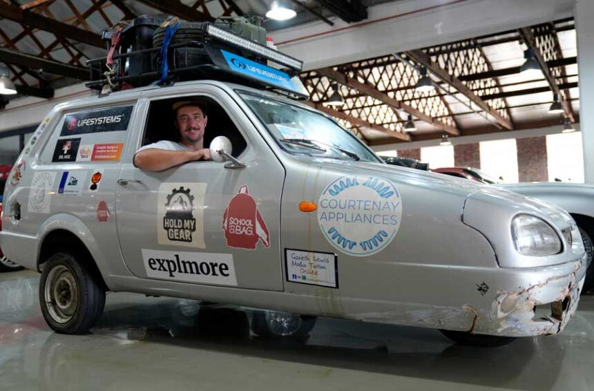 Oliver Jenks poses with the Reliant Robin called "Sheila the three-wheeler" he and Seth Scott drove from London to Cape Town in a bid to break a Guinness World Record for being the first to do the journey in a three-wheeled car in Cape Town, South Africa, Friday, March 20, 2026.