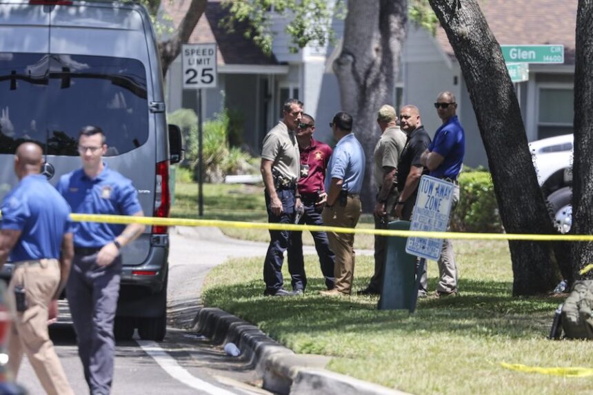 Detectives with the Hillsborough County Sheriff's Office join an investigation inside the Lake Forest subdivision of Tampa, Fla., on Friday, April 24, 2026, where authorities said a man was taken into custody after barricading himself inside a home, in connection to the search for two missing University of South Florida graduate students.