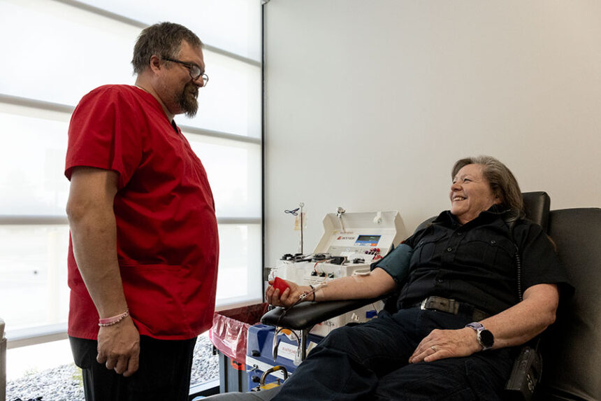 American Red Cross Drive Lead Byron Wilkinson talking with EMS Deb Wright during her donation at the Battle of the Badges Blood Drive. | Daniel V. Ramirez, EastIdahoNews.com