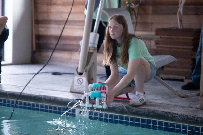 Everlee Graham, a sixth grader at Westside Elementary School, picks up her SeaPerch team's underwater robot while practicing in the pool at Motel West on Wednesday. | Cody Roberts, EastIdahoNews.com