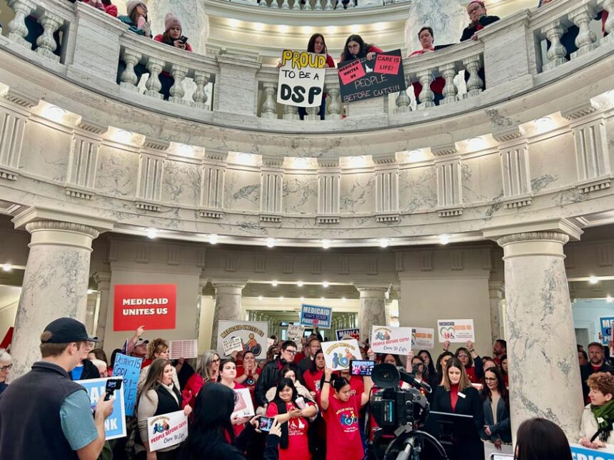 Hundreds of Idahoans gathered in the rotunda of the Idaho Capitol on Jan. 12, 2026, to protest proposed cuts to the state’s Medicaid program. The protest, organized by Idaho Voices for Children, took place before the governor’s State of the State Address. | Christina Lords, Idaho Capital Sun