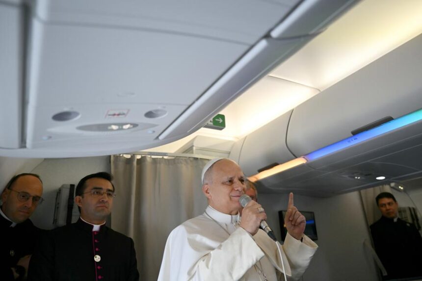 Pope Leo XIV speaks to journalists aboard his flight bound for Algiers’ Houari Boumédiène International Airport on Monday, April 13, 2026, at the start of an 11-day apostolic journey to Africa. (Alberto Pizzoli/Pool Photo via AP)