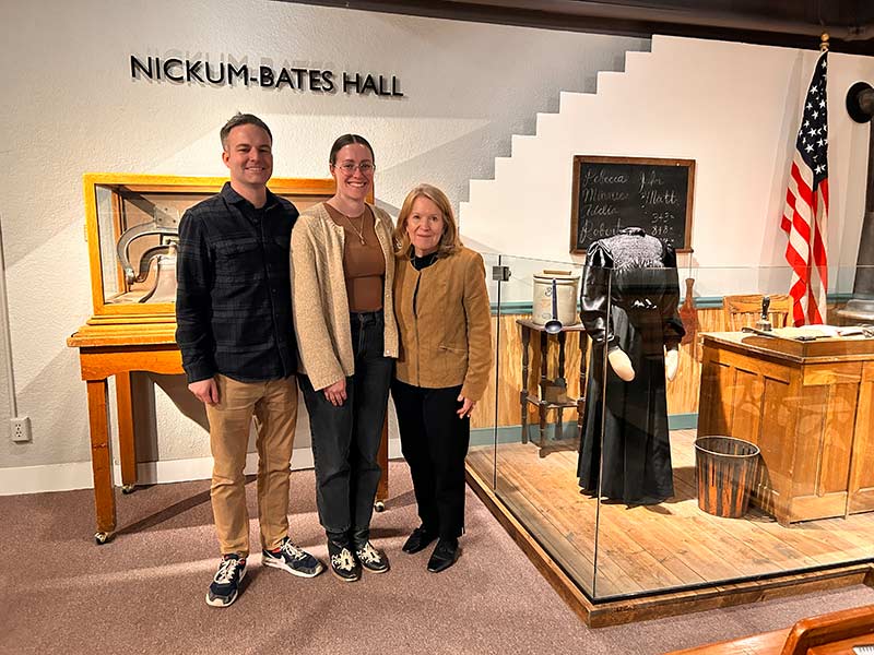 Jeff Carr, left, Chloe Doucette, center, and Callie Avondet, next to the Rebecca Mitchell display in the Museum of Idaho. | Rett Nelson, EastIdahoNews.com