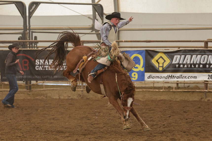 Firth Ryder Wallace rides bareback during the District 4 Idaho High School Rodeo at Pocatello