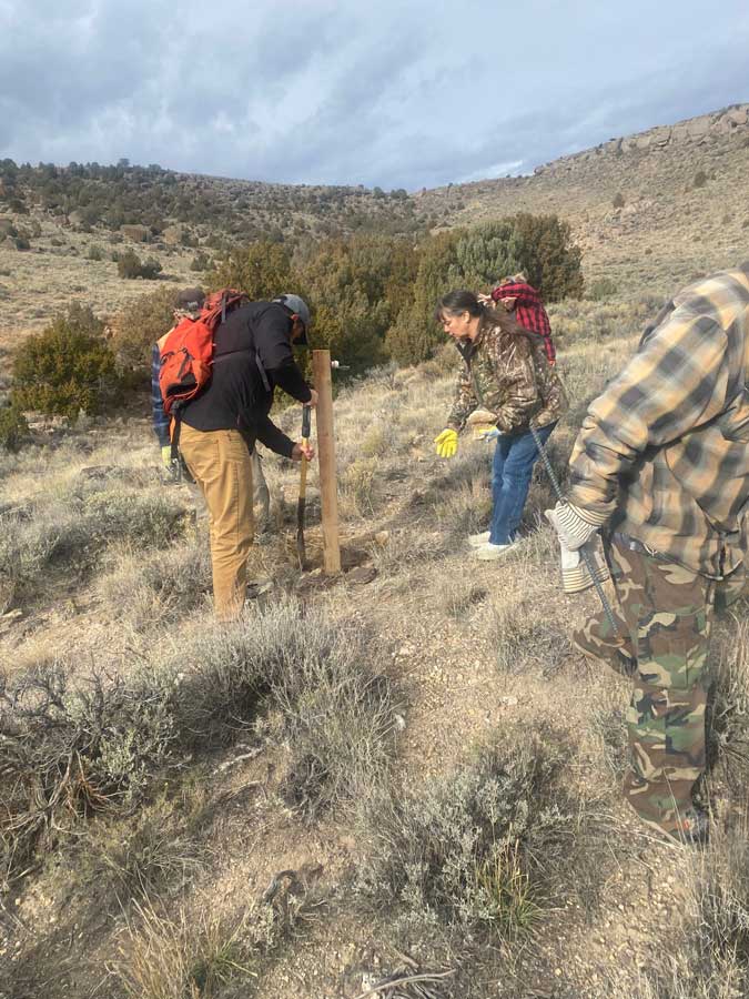 Club members setting corner posts on a claim that has been filed on.