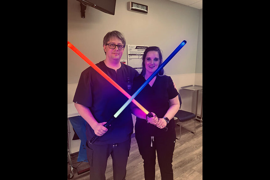 Dustin Fielder and Andee Fielder holding lightsabers after their May 4 wedding inside of the Idaho Falls Community Hospital. | Courtesy Andee Fielder