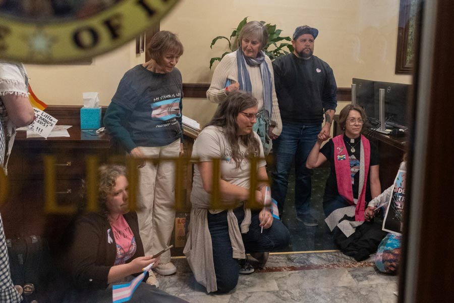 Protestors listen to an Idaho State Police Trooper, minutes before they were arrested in Idaho Gov. Brad Little’s office on Wednesday, April 1, 2026. | Kyle Pfannenstiel, Idaho Capital Sun
