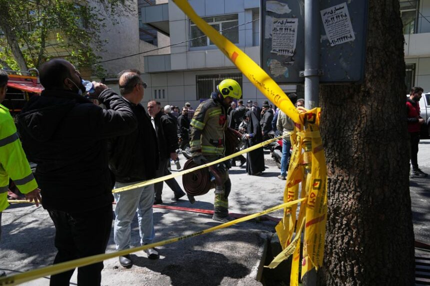 A first responder leaves the site of a strike that, according to a security official at the scene, destroyed half of the Khorasaniha Synagogue and nearby residential buildings in Tehran, Iran, Tuesday, April 7, 2026. | Francisco Seco, Associated Press