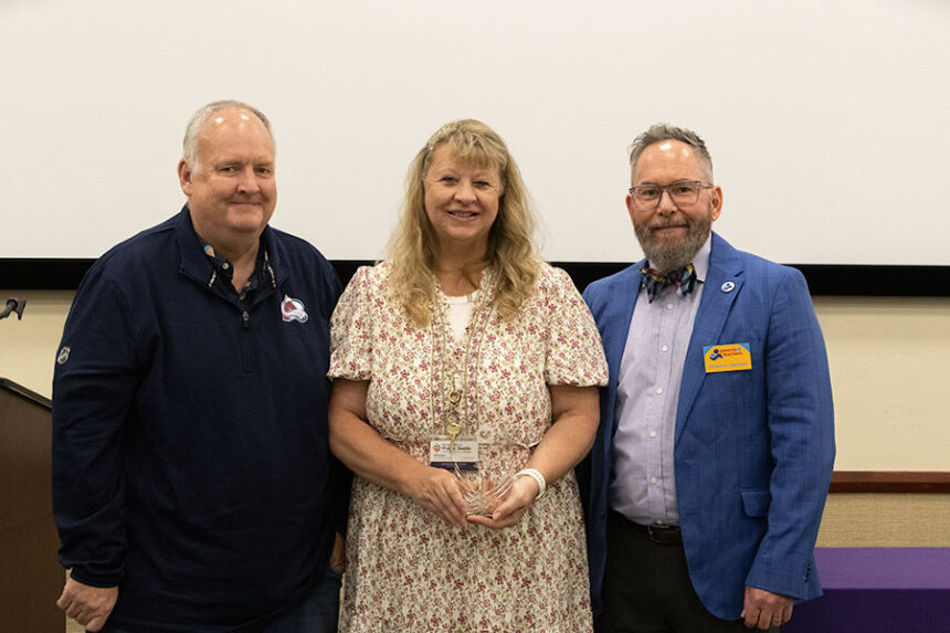 Wendy Welch (middle) received the "2026 National Home Visitor of the Year" award on April 22, 2026. She stands next to "Parents as Teachers" national director of government and community engagement Benjamin Hazelton (right) and her husband Scott Welch (left).