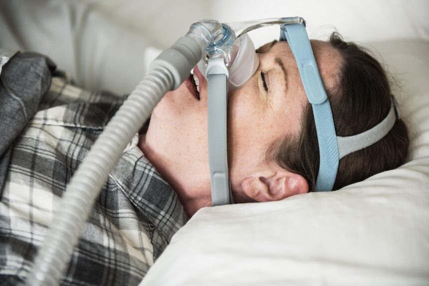 a woman sleeping with anti snoring chin strap 2026 01 07 23 56 45 utc
