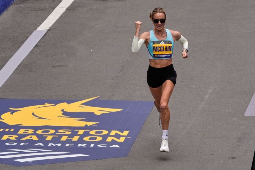 Jess McClain of Phoenix, the top American woman finisher, pumps her fist while approaching the finish line of the Boston Marathon, Monday, April 20, 2026, in Boston. (AP Photo/Charles Krupa)