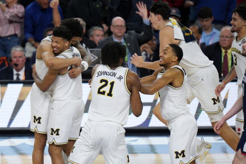 Michigan celebrates after defeating UConn in the NCAA college basketball tournament national championship game at the Final Four, Monday, April 6, 2026, in Indianapolis. (AP Photo/AJ Mast)