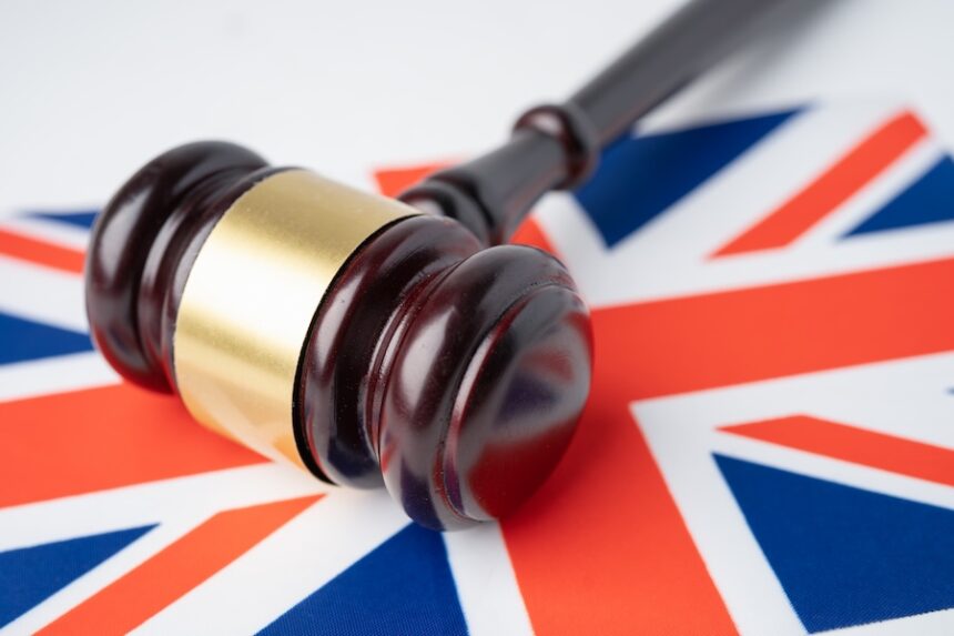Gavel for judge lawyer on United Kingdom flag, finance concept.