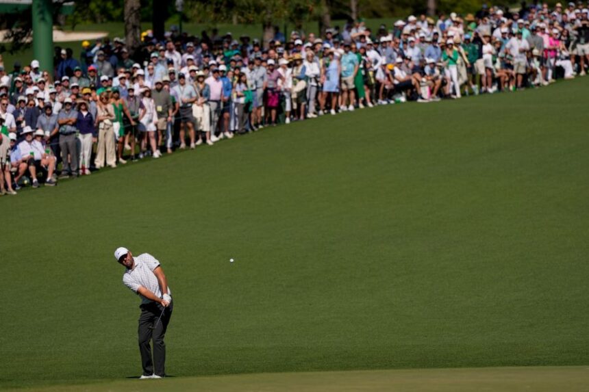 Scottie Scheffler chips to the green on the second hole during the second round of the Masters golf tournament at the Augusta National Golf Club, Friday, April 10, 2026, in Augusta, Ga. (AP Photo/David J. Phillip)