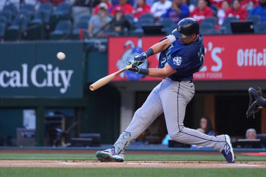 Seattle Mariners' Cal Raleigh connects on a solo home run off Texas Rangers starting pitcher Jacob deGrom during the first inning of a baseball game Monday, April 6, 2026, in Arlington, Texas. (AP Photo/Julio Cortez)