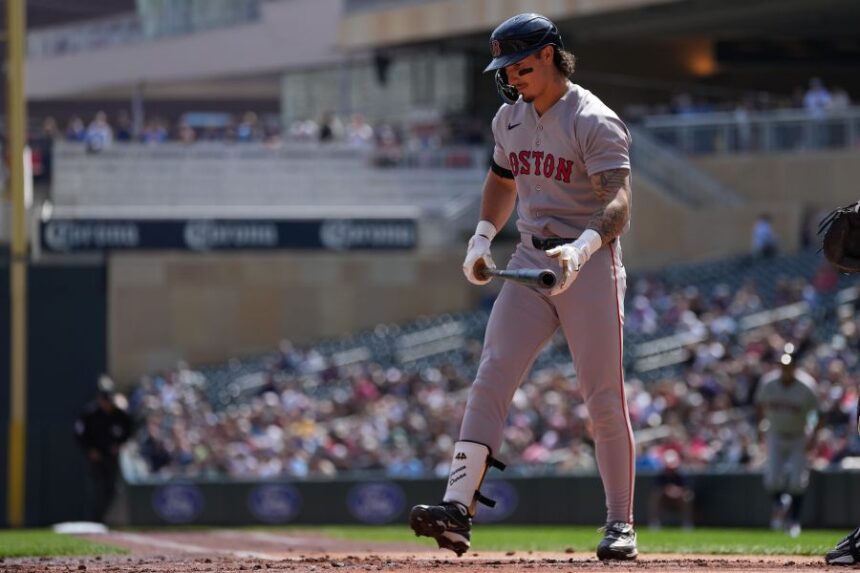 Boston Red Sox's Jarren Duran walks back to the dugout after striking out during the first inning of a baseball game against the Minnesota Twins Wednesday, April 15, 2026, in Minneapolis. (AP Photo/Abbie Parr)