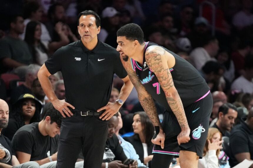 Miami Heat head coach Erik Spoelstra listens to center Kel'el Ware (7) during the second half of an NBA basketball game against the Washington Wizards Saturday, April 4, 2026, in Miami. (AP Photo/Marta Lavandier)