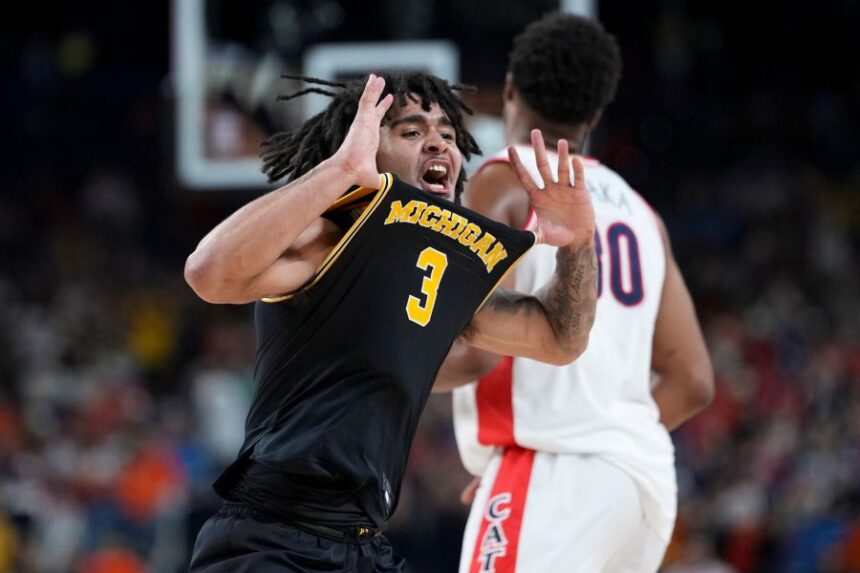 Michigan guard Elliot Cadeau (3) celebrates a basket against Arizona during the second half of an NCAA college basketball tournament semifinal game at the Final Four, Saturday, April 4, 2026, in Indianapolis. (AP Photo/Abbie Parr)