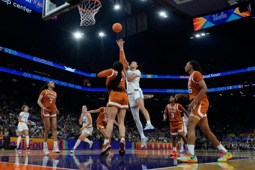 UCLA center Lauren Betts (51) shoots against Texas during the first half of a women's NCAA college basketball tournament semifinal game at the Final Four, Friday, April 3, 2026, in Phoenix. (AP Photo/Ross D. Franklin)