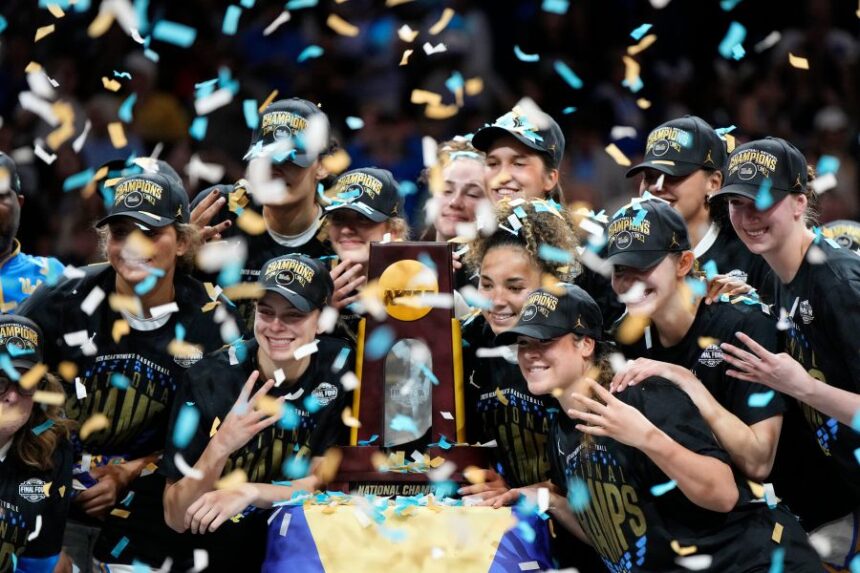 UCLA players celebrate after defeating South Carolina in the women's National Championship Final Four NCAA college basketball tournament game, Sunday, April 5, 2026, in Phoenix. (AP Photo/Ross D. Franklin)