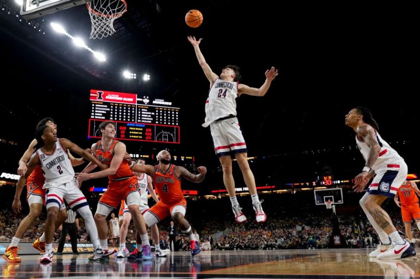 UConn guard Braylon Mullins (24) rebounds against Illinois during the second half of an NCAA college basketball tournament semifinal game at the Final Four, Saturday, April 4, 2026, in Indianapolis. (AP Photo/Abbie Parr)