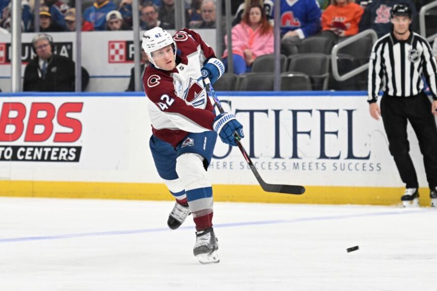Colorado Avalanche's Josh Manson (42) takes a shot against the St. Louis Blues during the third period of an NHL hockey game, Tuesday, April 7, 2026, in St. Louis. (AP Photo/Joe Puetz)