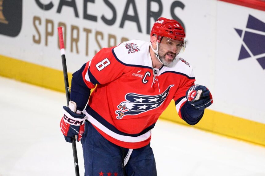 Washington Capitals left wing Alex Ovechkin motions to the crowd after he scored his 1,000th career goal combining regular season and playoffs during the third period of an NHL hockey game against the Colorado Avalanche, Sunday, March 22, 2026, in Washington. (AP Photo/Nick Wass)