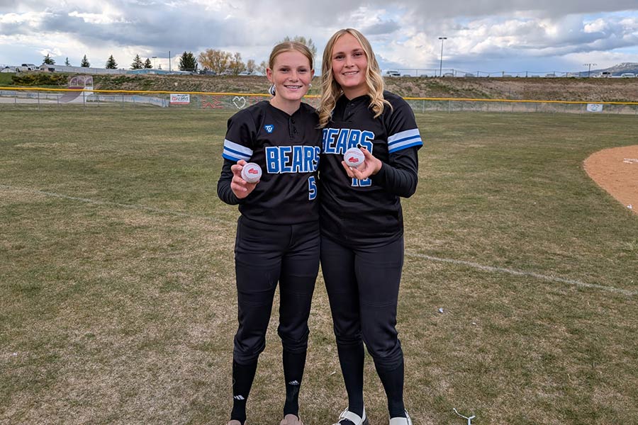 Elle (left) and Kambria Romrell receive game balls