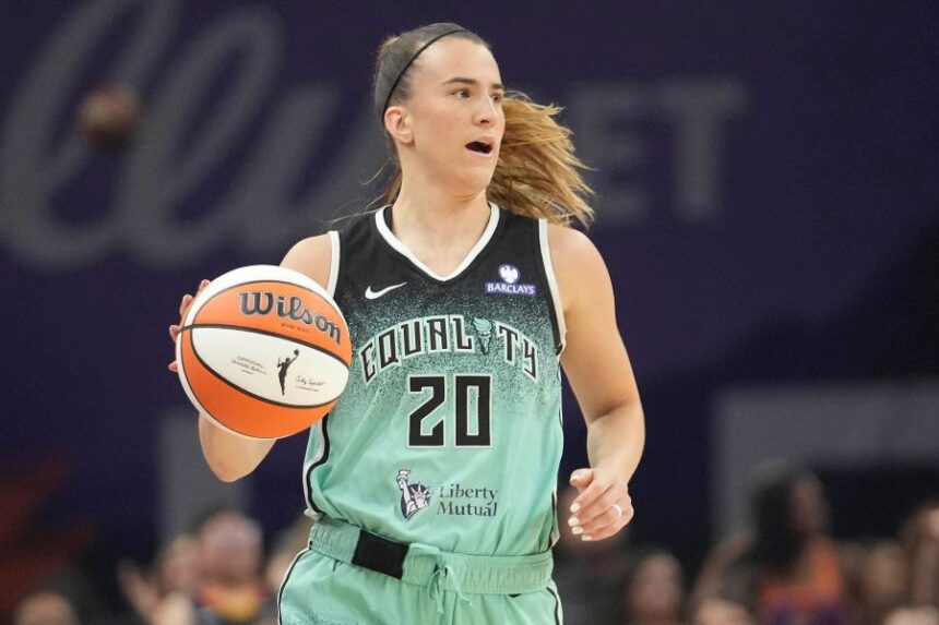 FILE - New York Liberty guard Sabrina Ionescu controls the ball against the Phoenix Mercury during the second half of Game 1 during the first round of the WNBA basketball playoffs Sept. 14, 2025, in Phoenix. (AP Photo/Darryl Webb, File)
