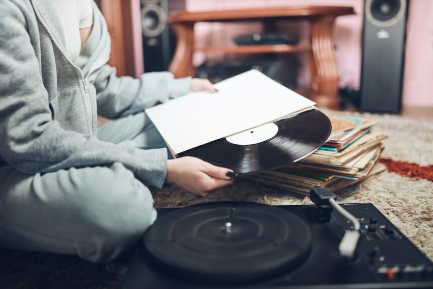 Woman with Vinyl Record at Home Listening Music