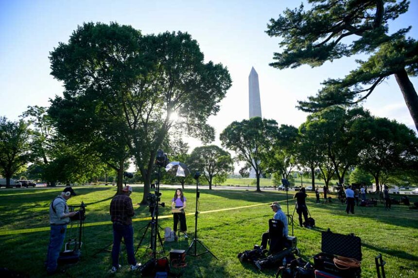 Journalists report as U.S. Secret Service and local police remain after a person was shot by law enforcement near the Washington Monument in Washington, Monday, May 4, 2026.
