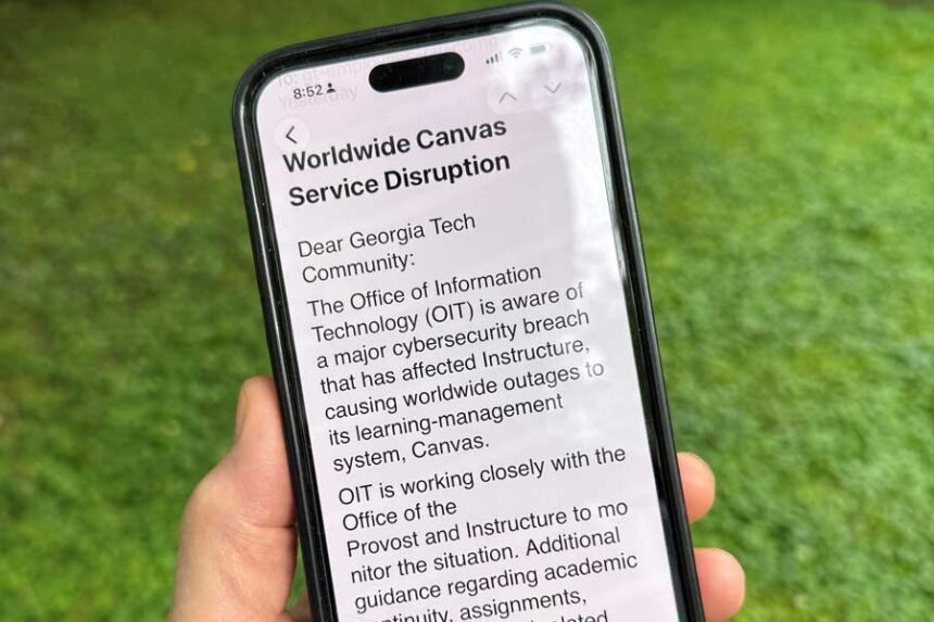 An image of a notice sent by Georgia Tech's information technology department warning students, professors and staff about the cybersecurity breach of the Canvas system it uses for assignments and grading is displayed on a phone, Friday, May 8, 2026, in Decatur, Georgia.
