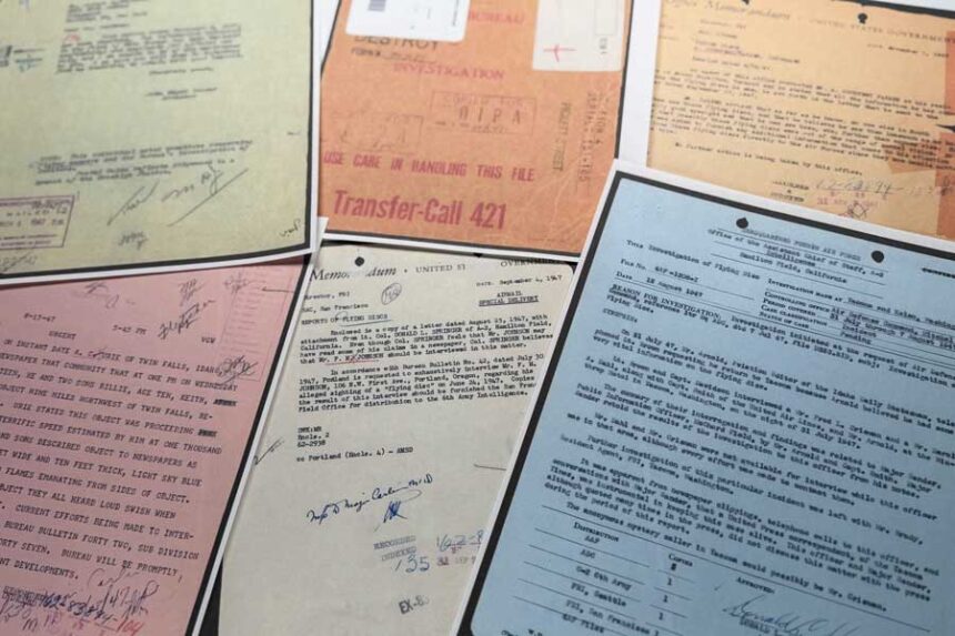 Files on UFOs, released Friday, May 8, 2026, by the Pentagon, are photographed in Washington.
