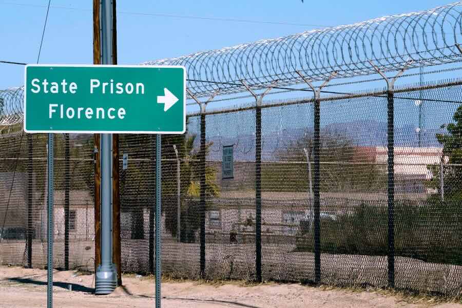 FILE - A sign points in the direction of the Arizona State Prison in Florence, Ariz., March 19, 2025.